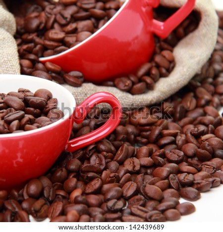 coffee beans in ceramic red coffee cup