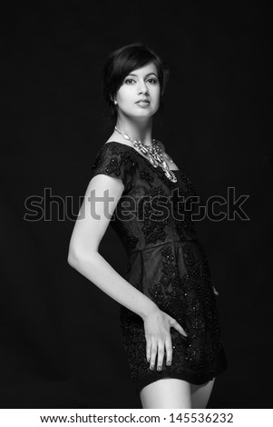 Black and white image of a beautiful young woman in a long dress/Fashionable photo of young woman