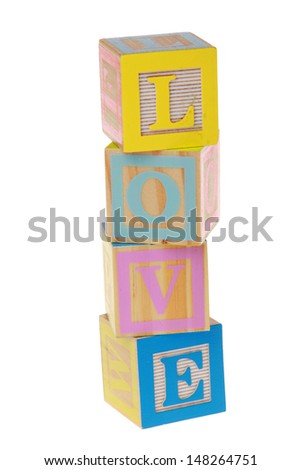 Toy letters that spell love against a white background