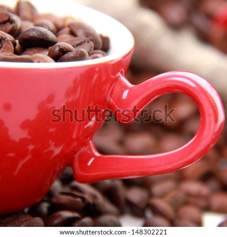 Coffee beans in ceramic red coffee cup