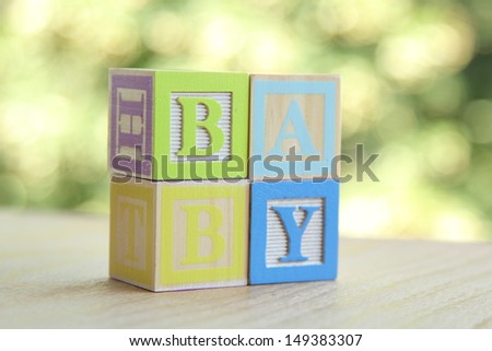 Word baby lined with children\'s wooden blocks for elementary education alphabet