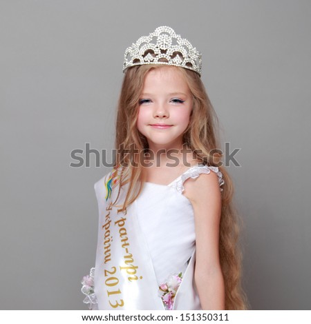 Beautiful little girl in a white dress with ribbon and the words in Ukrainian 