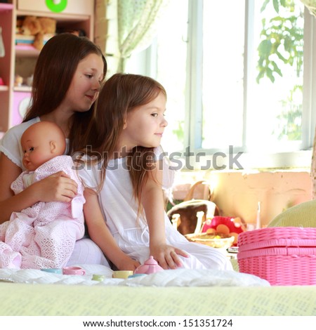 Happy cheerful young children in the room playing with toys and smiling on the background of bright toys