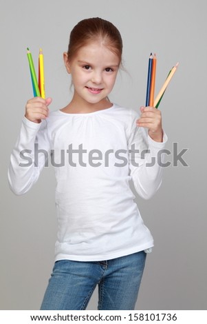 Portrait of lovely girl holding a pencils on Education