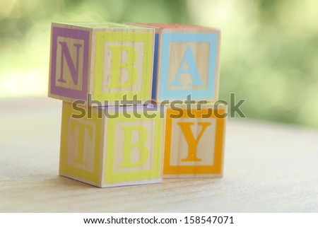 Word baby lined with children\'s wooden blocks for elementary education alphabet