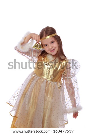 Charming smiling young child with an angelic smile in a beautiful fancy dress holding a golden moon on a white background on Holiday