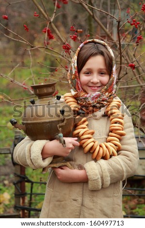 little girl in russian village traditional kerchief with round cracknel/traditional russian little girl with samovar at autumn outdoor