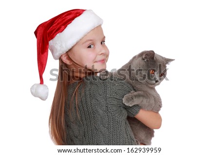 The best christmas present ever - happy little girl with her new cat isolated on Holiday theme/Lovely girl and British cat