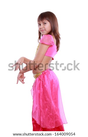 Little arabic belly-dancer wearing pink dress isolated on white on Holiday theme/Portrait of pretty little dancer posing on camera