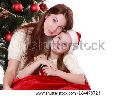 happy mother and daughter over christmas tree on Holiday theme isolated on white/happy mother and daughter over christmas tree