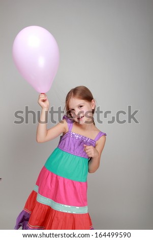 Girl with a pink air balloon on Holiday