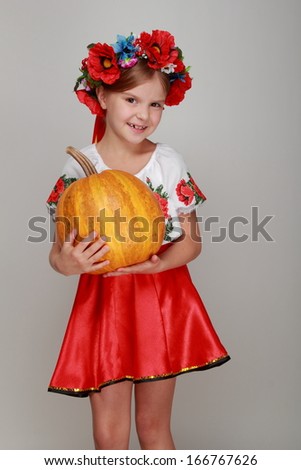 Young beautiful Ukrainian girl in a wreath with with pumpkin on Food and Drink