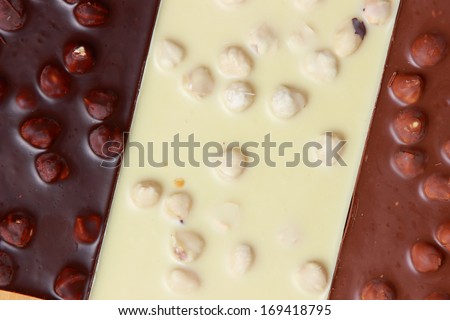 bar of chocolate and nuts/Pile of assorted chocolate bars close-up