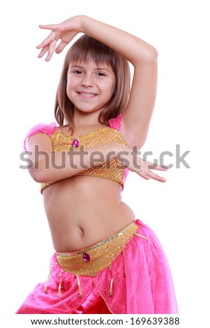 Little arabic belly-dancer wearing pink dress isolated on white on Holiday theme/Portrait of pretty little dancer posing on camera