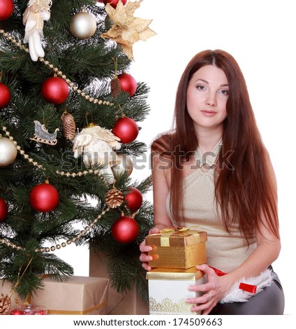 Studio image of beautiful smiley woman over Christmas tree over white background on Holiday theme/Portrait of lovely woman decorating christmas tree