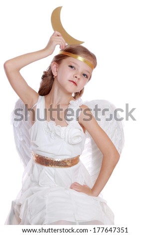 Christmas holiday theme. Cute angel girl with big golden moon sitting on a cloud on Holiday theme/Image of beautiful angelic kid on Christmas theme over white background