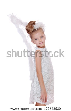 Beautiful young girl wearing angel wings on Holiday theme/Portrait of Angel little girl posing on camera