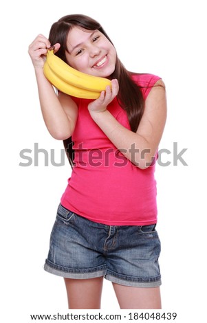 Cheerful little girl holding yellow bananas/Happy girl holds a bunch of bananas, isolated on white