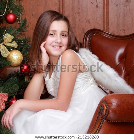 Cute home portrait of beautiful little girl as an angel over Christmas decoration on Holiday theme/Christmas - Cute little Angel