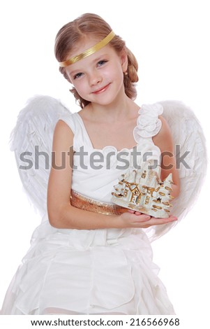 Image of pretty happy smiley little angel with toy tiny house isolated on white on Holiday theme/Little angel holding nice house on isolated background