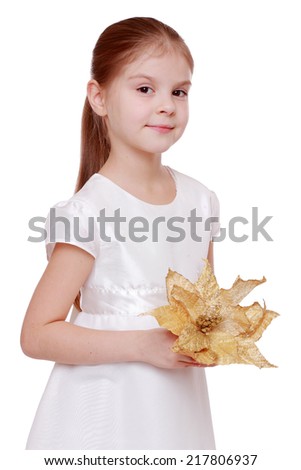 Image of happy pretty little girl in beautiful white dress holding a decorative golden autumn leaves isolated on white