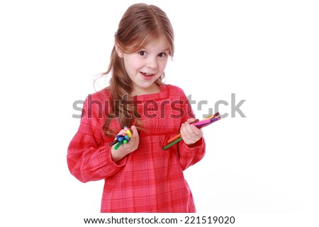Beautiful little girl holding colorful felt-tip pens isolated on white/European kid with felt-tip pens