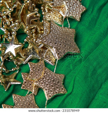golden stars over green background/golden stars over green fabric texture pattern background