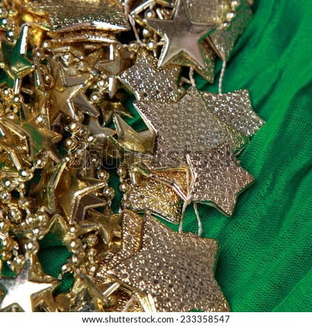 golden stars over green background/golden stars over green fabric texture pattern background