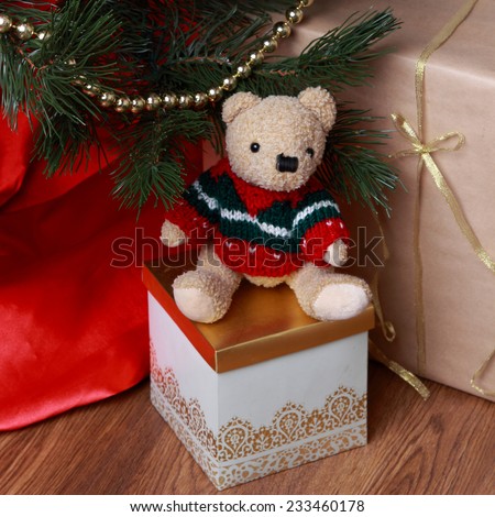 Christmas decoration with antique teddy bear over wooden background on Holiday theme Lovely toy bear over presents on Christmas theme