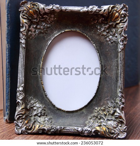 vintage photo frame over wooden background/photo frame on old table