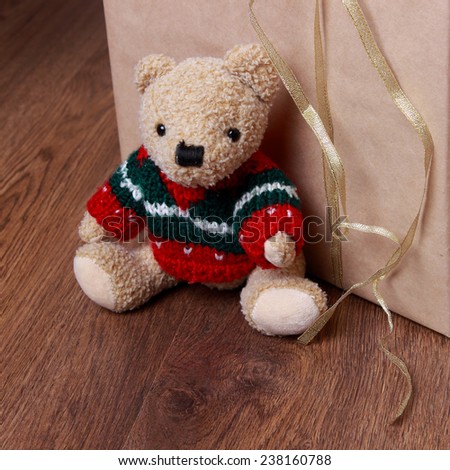 Christmas decoration with antique teddy bear over wooden background on Holiday theme/Lovely toy bear over presents on Christmas theme