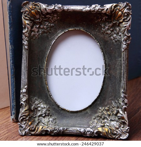 vintage photo frame over wooden background/photo frame on old table