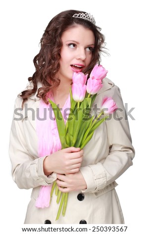 Beautiful young girl with cute haircut holding a bouquet of pink tulips on a white background for Valentine\'s Day