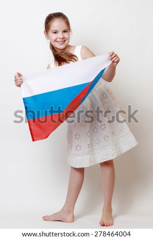 Cheerful beautiful little girl holding national flag of Russian Federation (Russia)