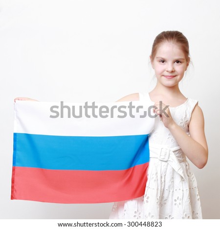 Cheerful beautiful little girl holding national flag of Russian Federation (Russia)