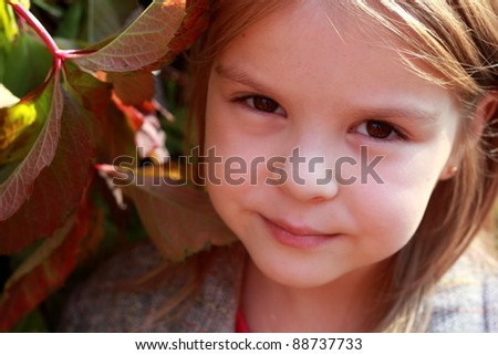 Little Miss. Pretty cute girl walks in autumn park/Close-up portrait of lovely girl