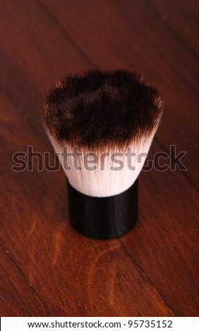 brown make up brush over dark brown background on beauty theme/make up brush
