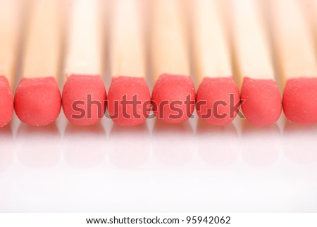 some wooden matches in line over white background/matches with the reflection