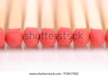 Wooden matches in line over white background/matches with the reflection