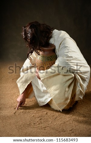Jesus writing with finger in the sand