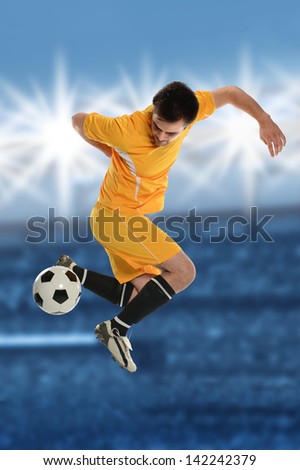 Soccer player performing back kick in stadium at dusk