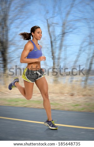 African American woman running outdoors