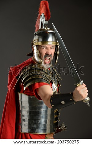 Portrait of Roman Centurion brandishing sword over neutral background