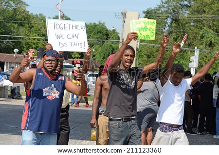 FERGUSON, MO/USA AUGUST 15, 2014: Demonstrator at the site of destroyed Quick Trip react after Police Chief Thomas Jackson release of the name of the officer that shot Michael Brown.