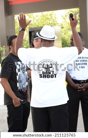 FERGUSON, MO/USA  AUGUST 15, 2014: Demonstrator interview at the site of destroyed Quick Trip react after Police Chief Thomas Jackson release of the name of the officer that shot Michael Brown.