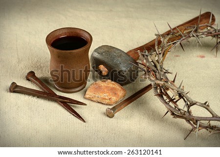 Communion elements with crown of thorns and nails over vintage cloth