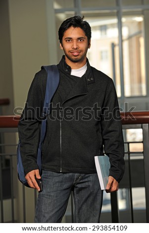 Portrait of young Indian student inside school building