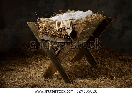 Manger with hay and swaddling clothes in old stable