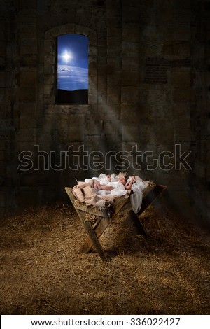 Baby Jesus resting on a manger with light from the star filters through window