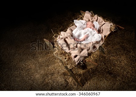 New born Jesus laying on a manger over dark background